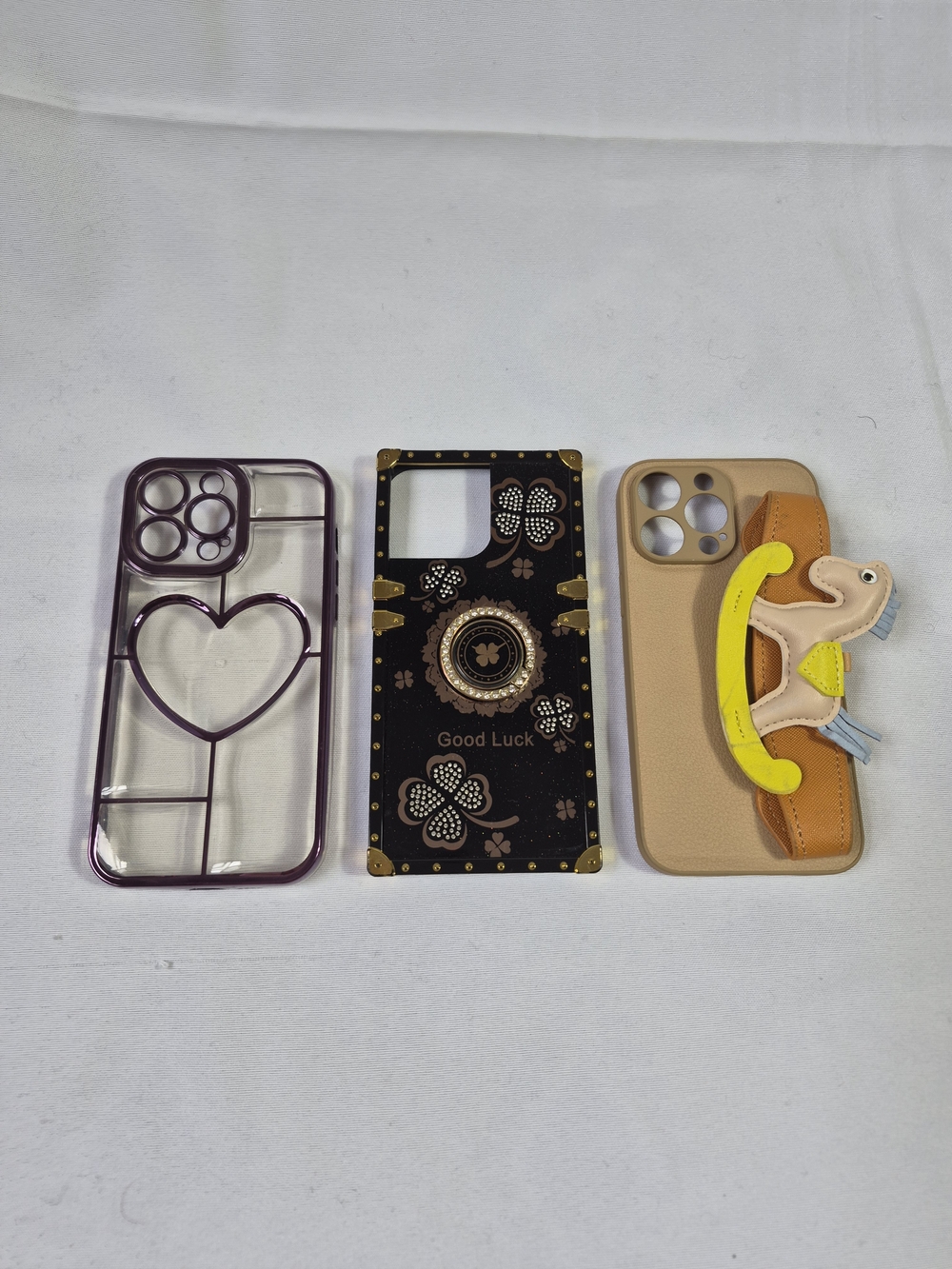 Phone Case Trio- Purple Clear Heart, Black Good Luck, Beige Rocking Horse Handle